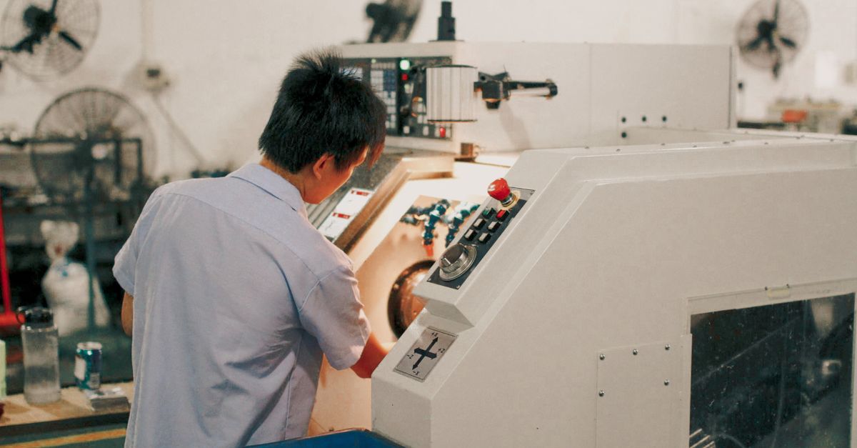 Operator running a CNC lathe control panel