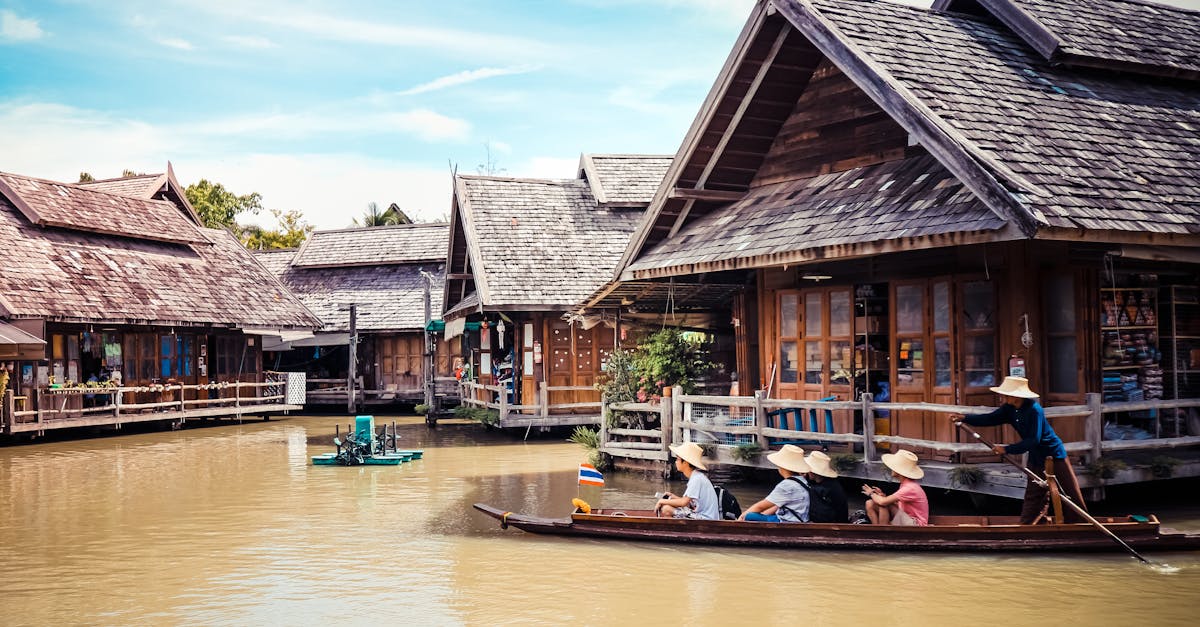 Traditional floating-market boats carrying visitors through stilt houses